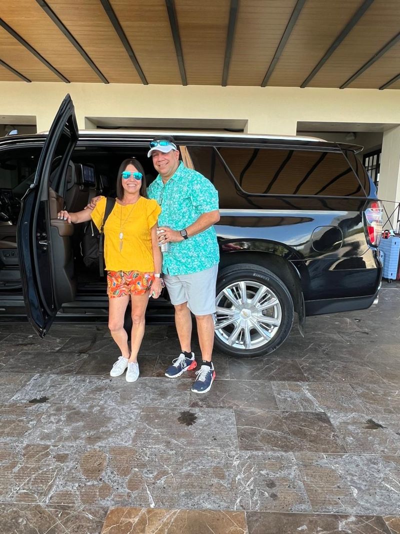 Couple beside a Layla Escalade with the door open at a resort lobby